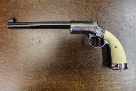 22 WMR bolt-action single-shot pistol, with 10" barrel, adjustable sights and walnut grip. . Hy hunter firearms